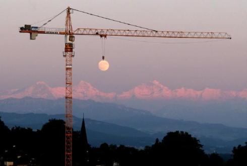 Crane Lifting Moon